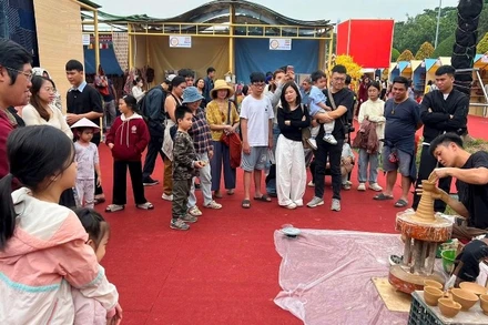 Du khách xem nghệ nhân gốm Phù Lãng (Bắc Ninh) biểu diễn làm gốm tại Festival Bảo tồn và phát triển Làng nghề quốc tế 2025.