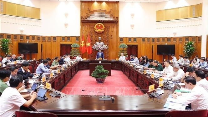 Thủ tướng Phạm Minh Chính chủ trì họp khắc phục hậu quả thiên tai sau bão. (Ảnh: Dương Giang/TTXVN)