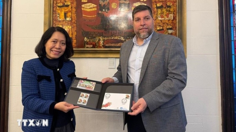 Nghị sĩ Victor Aldaya trao Đại sứ Ngô Minh Nguyệt bộ tem do Bưu chính Uruguay phát hành tháng 12/2013, nhân kỷ niệm 20 năm quan hệ ngoại giao Việt Nam-Uruguay, với chân dung của Đại tướng Võ Nguyên Giáp. (Ảnh TTXVN)