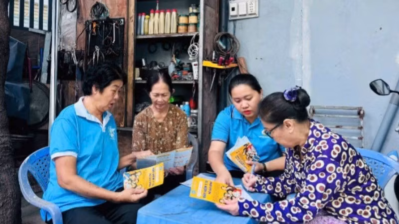 Nhân viên Bảo hiểm xã hội hướng dẫn người dân về bảo hiểm xã hội tự nguyện. (Ảnh: QUÝ HIỀN)