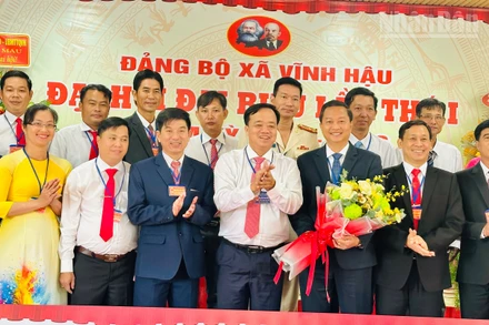 Đồng chí Phó Bí thư Thường trực Tỉnh ủy Cà Mau tặng hoa chúc mừng các đồng chí trong Ban Thường vụ, Ban Chấp hành Đảng bộ xã Vĩnh Hậu, nhiệm kỳ mới 2025-2030. (Ảnh: TRỌNG DUY)