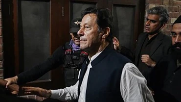 Cựu Thủ tướng Pakistan Imran Khan (phía trước) rời khỏi toà án ở Lahore, ngày 17/3/2023. (Ảnh: AFP/TTXVN)