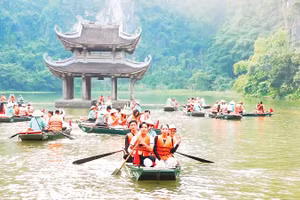 Khách du lịch tham quan quần thể danh thắng di tích Tràng An (Ninh Bình).