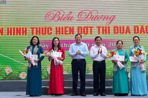 Lãnh đạo Tỉnh ủy Vĩnh Long trao kỷ niệm chương vì sự phát triển của Phụ nữ Việt Nam cho các chị em phụ nữ trong tỉnh. (Ảnh: HOÀNG TRUNG)