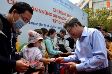 Ông Nguyễn Minh, Phó Chủ tịch Ủy ban nhân dân tỉnh Bình Thuận trao tận tay những phong bao lì xì cho hành khách vừa xuống tàu.