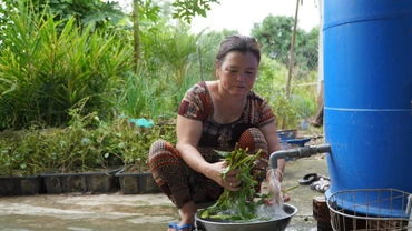 Bà Nguyễn Thị Bé, ngụ ấp Nhứt, xã An Phong, huyện Thanh Bình, Đồng Tháp, sử dụng nước sạch trong sinh hoạt hằng ngày. (Ảnh: Hữu Nghĩa)