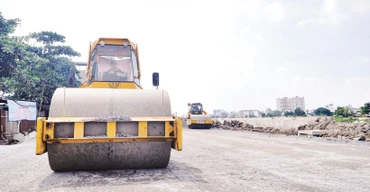 Thi công trải nhựa đường ven kênh Tham Lương, đoạn qua cầu Bến Phân đến cầu An Lộc trên địa bàn Quận 12, Thành phố Hồ Chí Minh. (Ảnh THẾ ANH)