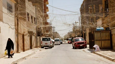 Người phụ nữ đi dọc theo một con phố tại thủ đô Baghdad, ngày 20/7. (Ảnh: Reuters)