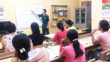 Đại úy Nguyễn Văn Luân, Đội trưởng Đội Vận động quần chúng (Đồn Biên phòng Ia Lốp) trong 1 tiết dạy môn Tiếng Việt cho người dân khu dân cư suối Khôn. 