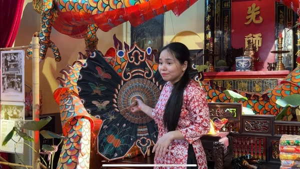Chị Nguyễn Minh Nguyệt, thuyết minh cho khách tham quan về quá trình phục dựng lồng đèn xưa.