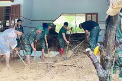 Cán bộ, chiến sĩ Lữ đoàn 574 giúp nhân dân sau mưa lũ.