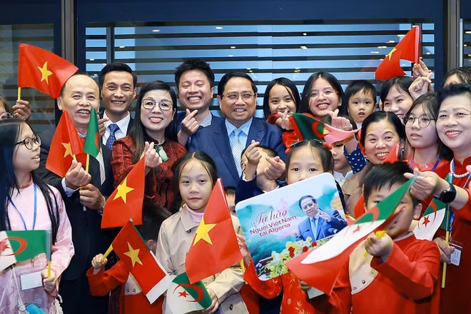 Thủ tướng Phạm Minh Chính và Phu nhân với cán bộ, nhân viên Đại sứ quán và đại diện cộng đồng người Việt Nam tại Algeria. (Ảnh: Dương Giang/TTXVN)