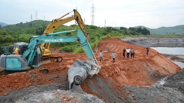 Các lực lượng cứu hộ tích cực thi công đê quây hàn khẩu bờ bao bị vỡ của hồ chứa nước thải của Nhà máy DAP Lào Cai, sáng ngày 9-9- 2018.
