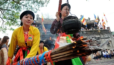Các cô gái trong phần thi nấu cơm tại đình làng.