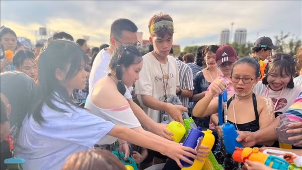 Người tham gia lễ hội chờ lấy nước để té vào nhau - một trong những điểm nổi bật của lễ hội Songkran. (Ảnh tư liệu: Huy Tiến/TTXVN)