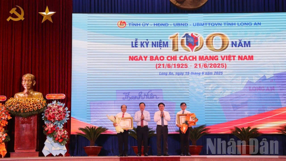 Thừa ủy quyền của Thủ tướng Chính phủ, Bí thư Tỉnh ủy Long An Nguyễn Văn Quyết (trái) và Chủ tịch UBND tỉnh Long An (phải) trao Bằng khen và hoa cho 2 cá nhân. longan4-3076.jpg