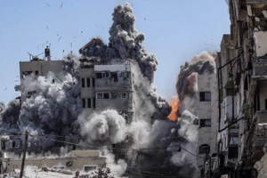 Các tòa nhà đổ sập trong một vụ không kích tại Dải Gaza.