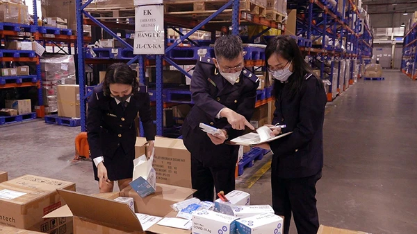 Lực lượng hải quan kiểm tra lô hàng bộ xét nghiệm nhanh Covid-19 vận chuyển từ Hàn Quốc về Việt Nam qua sân bay quốc tế Nội Bài. (Ảnh MINH CHIẾN)
