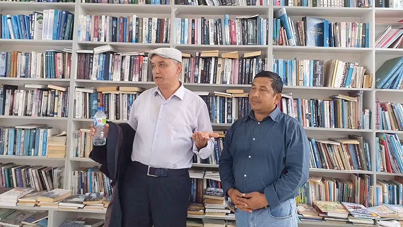 Nhà thơ Azam Obidov (trái) giới thiệu người sáng lập thư viện với các nhà thơ quốc tế.