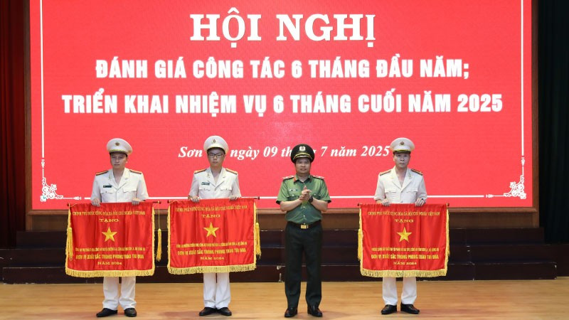 Thừa ủy quyền của Thủ tướng Chính phủ, Giám đốc Công an tỉnh Sơn La trao Cờ thi đua Chính phủ cho các tập thể có thành tích xuất sắc.