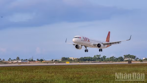 Vào lúc 7 giờ 5 phút, chuyến bay 9G1955 của Sun PhuQuoc Airways hạ cánh, trở thành chuyến bay thương mại đầu tiên trên đường cất hạ cánh mới. (Ảnh: ÁNH DƯƠNG)