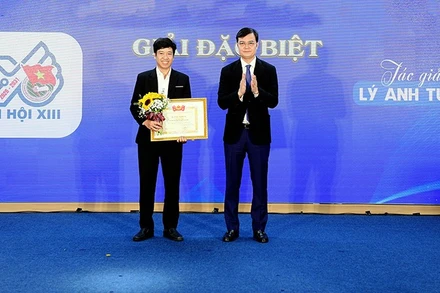 Bí thư Thứ nhất Trung ương Đoàn Bùi Quang Huy (bên phải) trao giải Đặc biệt của Cuộc thi sáng tác logo Đại hội Đoàn toàn quốc lần thứ XIII tặng tác giả Lý Anh Tuấn.