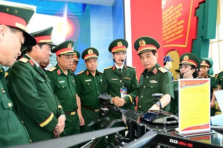 Đại tướng Phan Văn Giang kiểm tra khu trưng bày trong nhà của Bộ Quốc phòng tại Triển lãm thành tựu đất nước. (Ảnh VIỆT TRUNG)