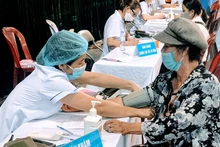 Các nhân viên y tế khám, tư vấn cho người dân trước khi tiêm vaccine phòng Covid-19.