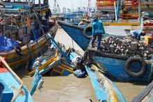 Tàu thuyền của ngư dân bị cuốn trôi và nhấn chìm khi neo đậu trong cảng cá La Gi.