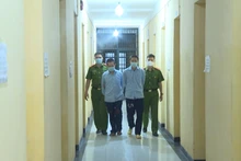 Lực lượng Công an dẫn giải hai đối tượng cầm đầu sàn tiền ảo.