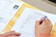 Thí sinh tham dự Kỳ thi tốt nghiệp THPT 2020 điền tờ khai y tế trước khi vào các điểm thi. Ảnh: THUỶ NGUYÊN