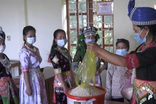 Phụ nữ bản Huồi Viêng xã Đoọc Mạy, huyện Kỳ Sơn góp gạo hỗ trợ hội viên nghèo.