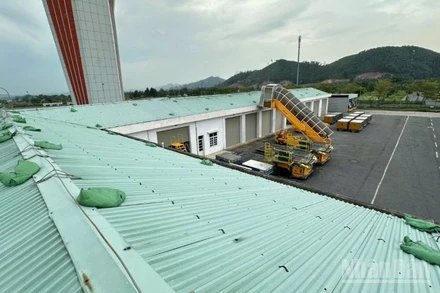 Gia cố bao cát tại mái nhà kho Cảng Hàng không quốc tế Vân Đồn.