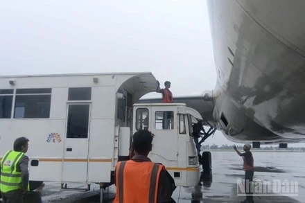 Xe cứu thương chuyên dụng tiếp cận máy bay Vietnam Airlines để chuyển khách.