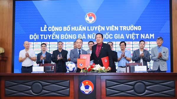 Huấn luyện viên Hoàng Văn Phúc (phải) ký kết hợp đồng cùng Liên đoàn Bóng đá Việt Nam. (Ảnh: VFF)