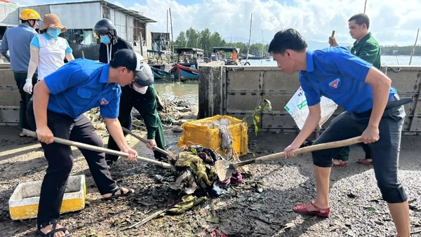 Đoàn viên thanh niên giúp người dân dọn bùn đất sau bão.