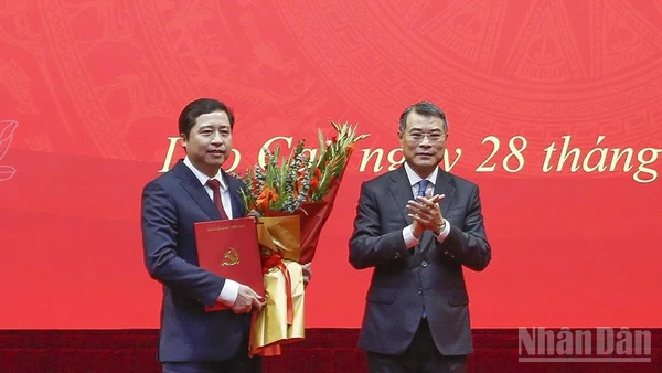 Đồng chí Lê Minh Hưng trao Quyết định và tặng hoa chúc mừng tân Bí thư Tỉnh ủy Lào Cai Dương Quốc Huy. (Ảnh: THANH SƠN)