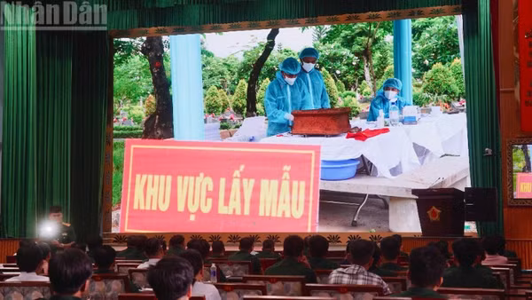Đại biểu theo dõi thước phim về công tác lấy mẫu hài cốt liệt sĩ. (Ảnh: LÊ THÀNH)