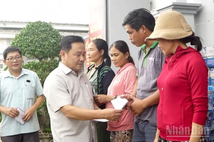 Phó Chủ tịch Hội đồng nhân dân thành phố Đà Nẵng Nguyễn Công Thanh tặng quà cho các hộ dân ở xã Quế Phước bị thiệt hại nặng do mưa lũ gây ra.