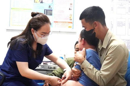 Nhân viên Trung tâm Kiểm soát bệnh tật Quảng Bình tiêm vaccine phòng dại cho trẻ em. (Ảnh: NH)