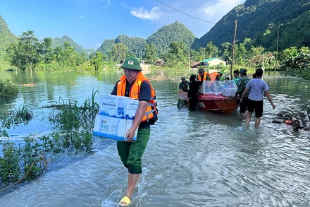 Lực lượng vũ trang vận chuyển nhu yếu phẩm cứu trợ người dân vùng ngập lũ.