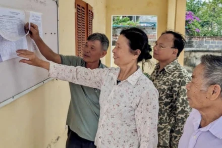 Cử tri xã Tự Tân (huyện Vũ Thư, tỉnh Thái Bình) xem niêm yết danh sách cử tri tham gia lấy ý kiến vào ngày 22/4 về sắp xếp đơn vị hành chính các cấp. (Ảnh: TIÊN DUNG)