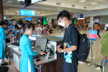 Hành khách sử dụng VNEID tại cửa ra tàu bay. (Ảnh: SƠN BÁCH)