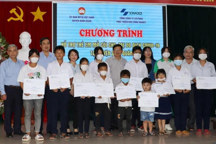 Đại diện lãnh đạo Tổng Công ty Sonadezi trao tiền hỗ trợ đợt đầu tiên cho các em mồ côi cha, mẹ vì dịch Covid-19 tại huyện Định Quán.