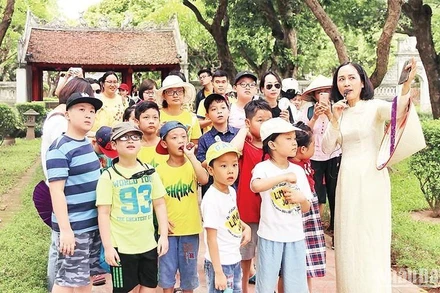 Các em học sinh tham quan, tìm hiểu về di tích Văn Miếu-Quốc Tử Giám tại Hà Nội. (Ảnh: Giang Nam)