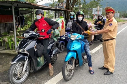 Cảnh sát giao thông Đà Nẵng tặng quà hỗ trợ người dân về quê đón Tết Nguyên đán 2023. (Ảnh: nhandan.vn)