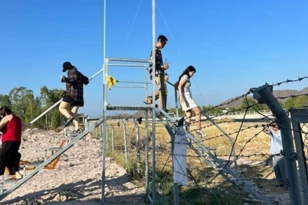 Người dân "xây dựng" cầu vượt để khách trèo qua hàng rào ngăn cách cao tốc Vĩnh Hảo-Phan Thiết với đường dân sinh thuộc huyện Hàm Thuận Bắc.