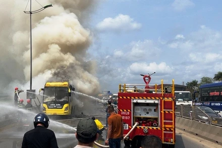 Các lực lượng chức năng nỗ lực khống chế hỏa hoạn trên xe ô-tô khách.