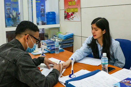 Người lao động tìm hiểu thông tin tại Trung tâm Dịch vụ việc làm Hà Nội. (Ảnh: nhandan.vn)