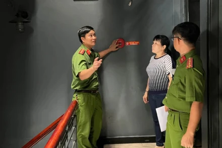 Lực lượng chức năng trao đổi với quản lý hệ thống karaoke Icool tại Thành phố Hồ Chí Minh về phòng cháy, chữa cháy. Ảnh: XUÂN PHÚ